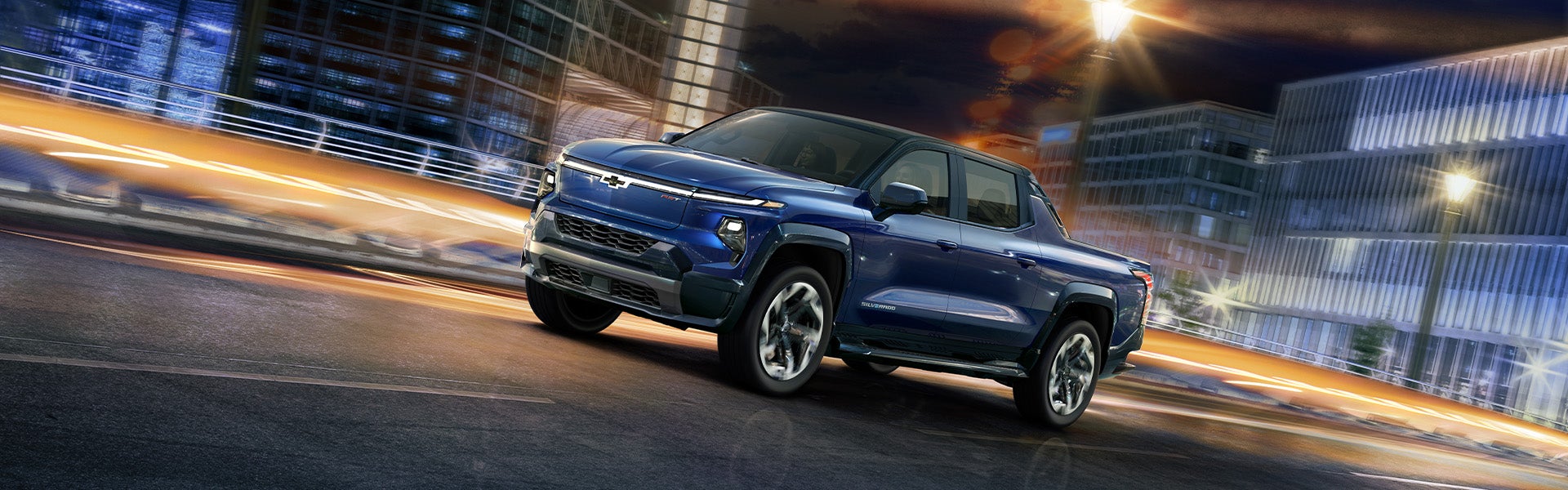 2023 Chevrolet Silverado EV drives down a bustling city street